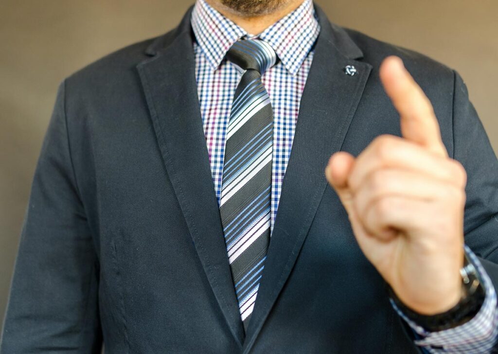 man in suit shaking finger