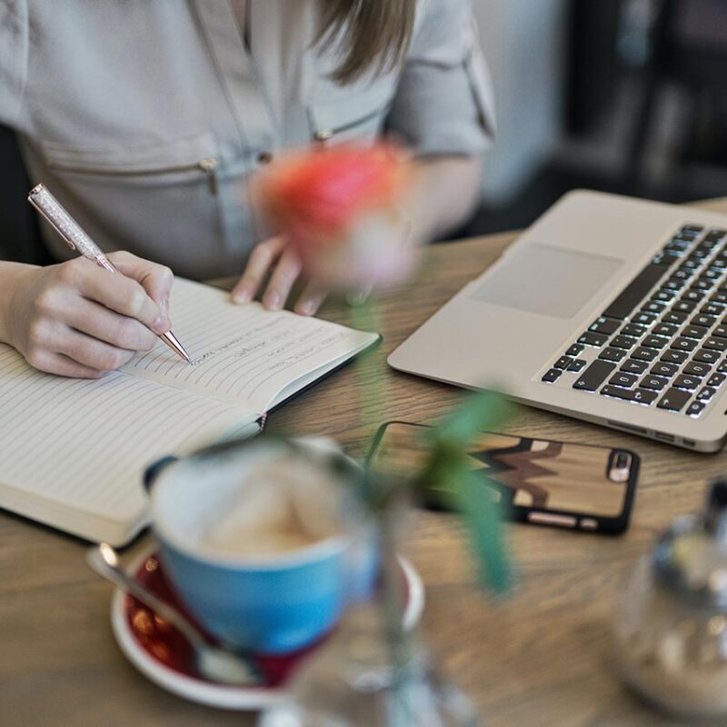 woman writing at desk